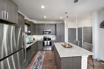 Center islands* with industrial glass pendant lighting